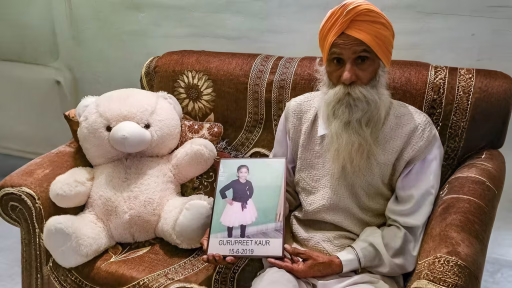Gurmeet Singh holds a photo of his granddaughter, Gurupreet Kaur, who died of heatstroke in Arizona